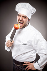 Wall Mural - Chef with apple on knife