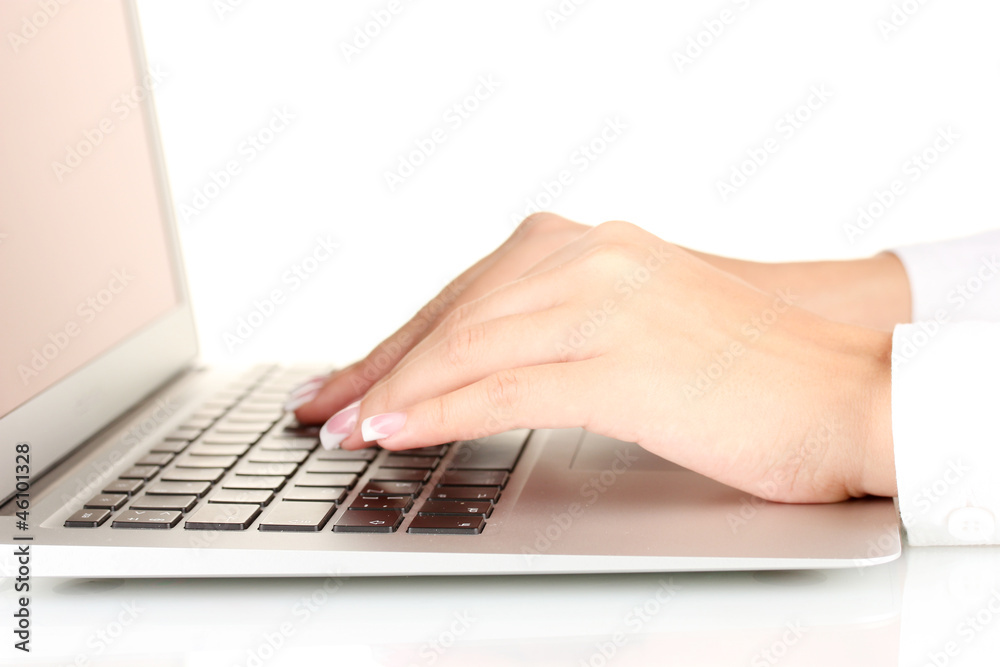 Hands typing on laptop keyboard close up
