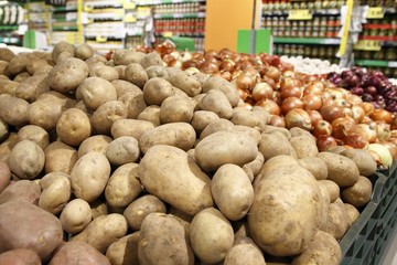 Potatoes and onions in a grocery