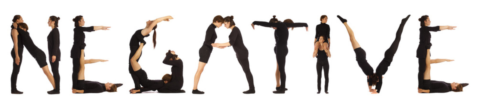 Black dressed people forming NEGATIVE word over white