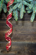 christmas fir tree with ribbon on wooden background