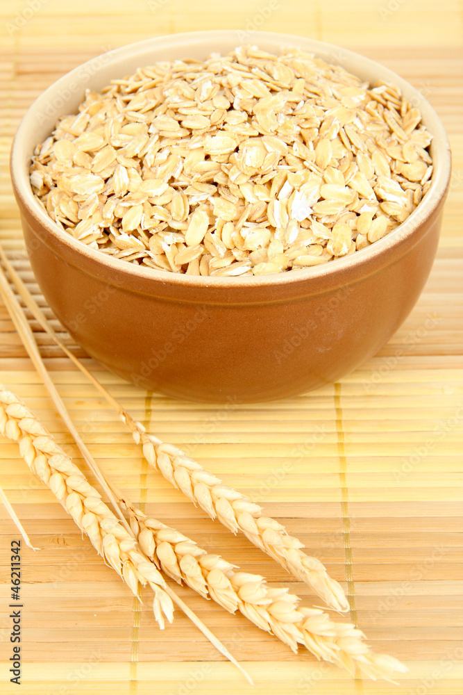 Brown bowl full of oat flakes