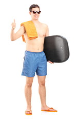 Poster - Male surfer posing with surfboard and giving a thumb up