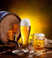 Sticker - Beer barrel with beer glasses on a wooden table.