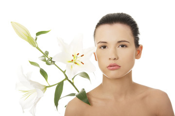 Young woman with health skin and with flower