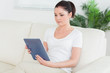 © WavebreakmediaMicro - Woman on the couch using a tablet pc