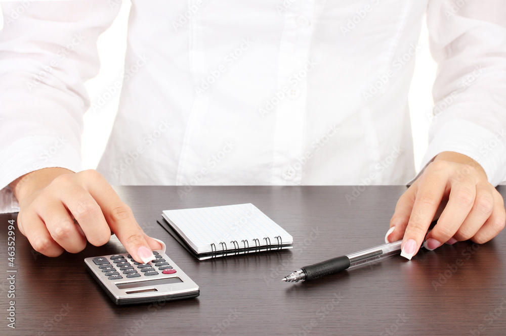 Woman's hands counts on the calculator, close-up
