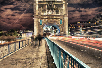 Canvas Print - Tower Bridge in London, UK at night with traffic and moving red