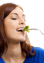 Cheerful woman eating broccoli, over white