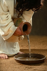 Jesus Pouring Water into Container