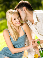 Young happy couple with champagne, outdoor