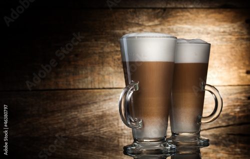 Fotografie, Obraz Fragrant coffee latte in glass cups on wooden background