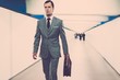 © Nejron Photo - Man in classic grey suit with briefcase walking through corridor