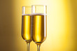 close up glasses of champagne on yellow background