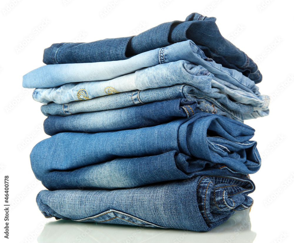 Lot of different blue jeans isolated on white