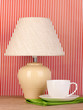table lamp and cup on striped background
