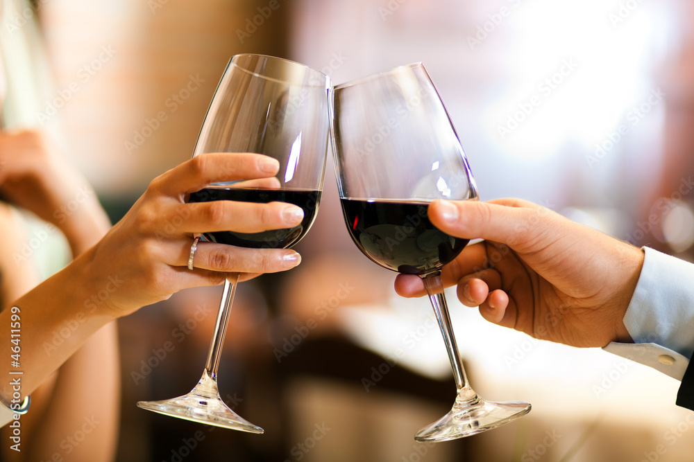 Male and female hands toasting wine glasses. Stock Photo | Adobe Stock