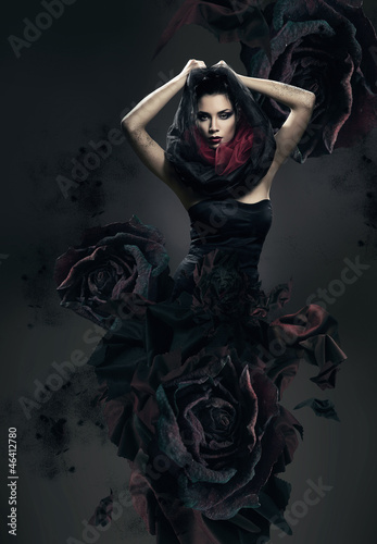 Fotografering mysterious woman in dark hood and rose dress