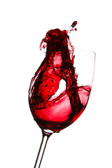 red wine splashing in a glass, isolated on white