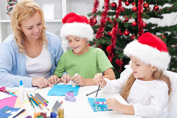 Family at christmas time making greeting cards