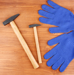 Poster - Hammers and gloves on wooden background