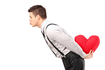 Sticker - A man holding a red heart shape object and giving kisses