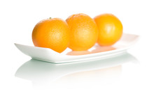 Oranges On Plate Isolated On White Background.