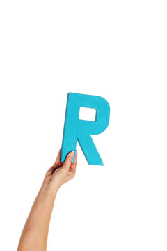hand holding up the letter R from the bottom
