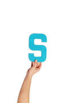 hand holding up the letter S from the bottom