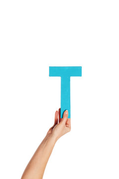 hand holding up the letter T from the bottom