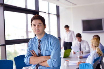 business man  on a meeting in offce with colleagues in backgroun