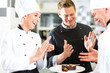 © Kzenon - Chef team in restaurant kitchen with dessert