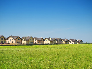 Wall Mural - Group of houses in the countryside. Sunny summer day