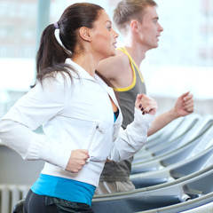 Woman and man at the gym exercising