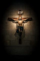 Crucifix in church on the stone wall.