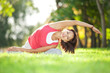 © Dmytro Sunagatov - Pretty woman doing yoga exercises in the park