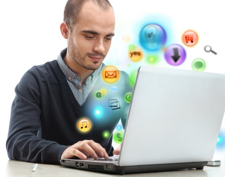 Young business man using his laptop for multimedia and site surf