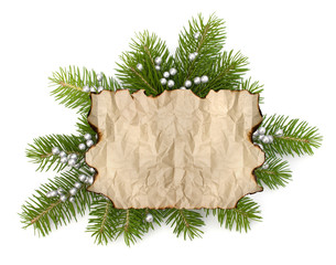 Old parchment paper with copy space on Christmas tree branch bac