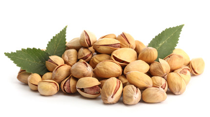 Wall Mural - tasty pistachio nuts with leaves, isolated on white