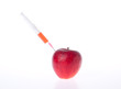 Apple and syringe with red liquid