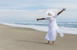 © spotmatikphoto - Happy African American Woman Dancing on Beach