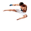© Mircea.Netea - Young fit man jumping, high kick and fist punch, muay thai equipment.