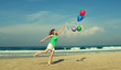 © dubova - Beautiful girl with a balloons on the beach. Old style colours.