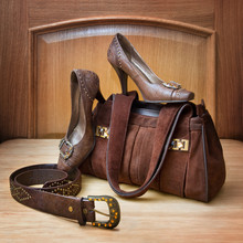 Brown Bag, Shoes And A Belt On Wooden Background