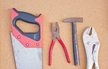 Set of tools over cork board.