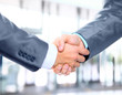 © ASDF - Closeup of a business hand shake between two colleagues