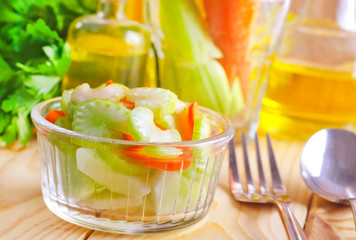 Poster - fresh salad with carrot and celery, salad in glass bowl