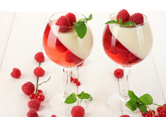 Wall Mural - fruit jelly with berries in glasses on wooden table