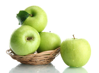 Wall Mural - Ripe green apples with leaves in basket isolated on white