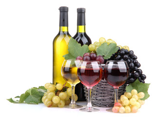 bottles and glasses of wine and grapes in basket, isolated